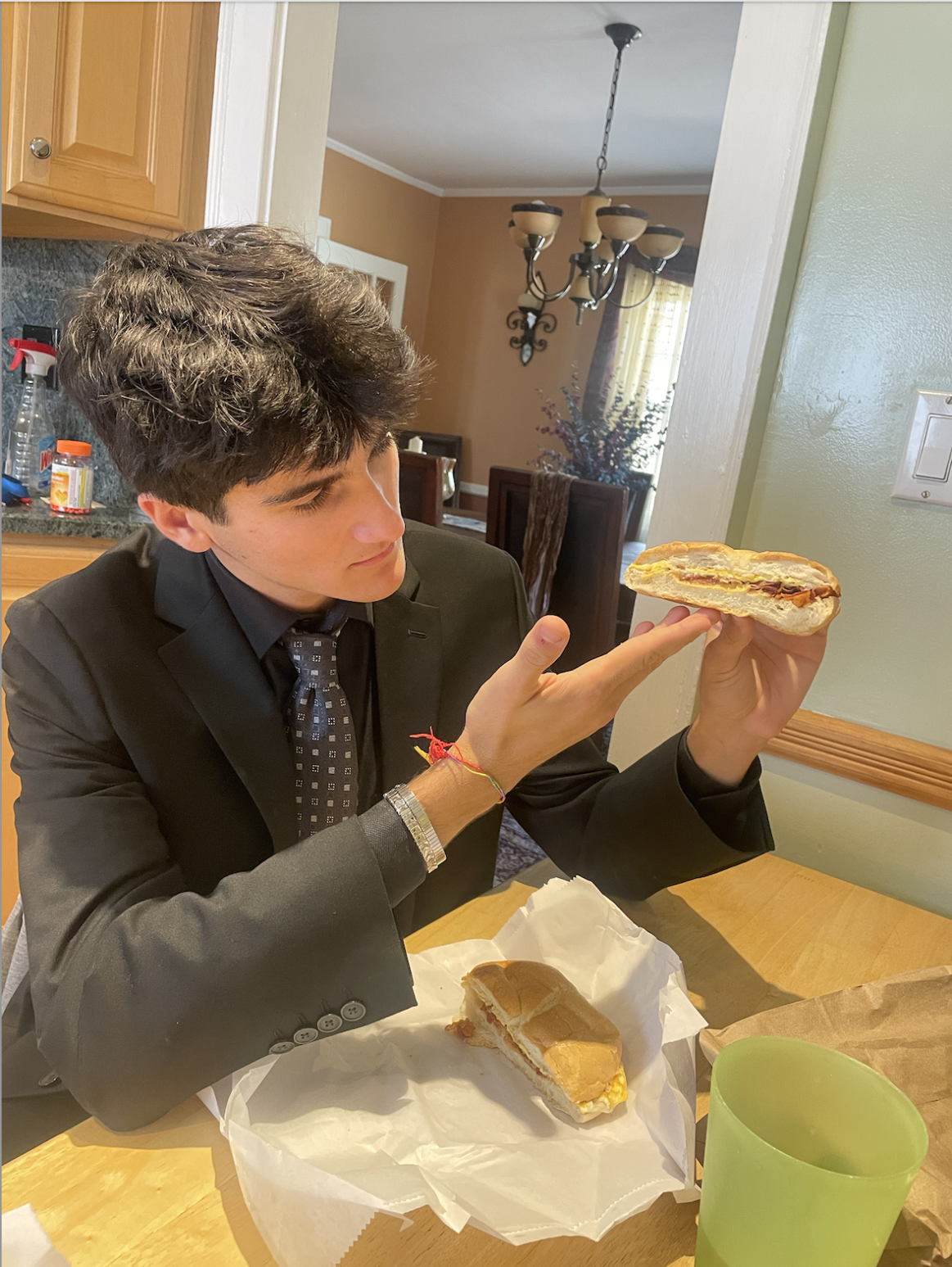 Christian Prencis holding a Remi's Bacon, egg, and cheese